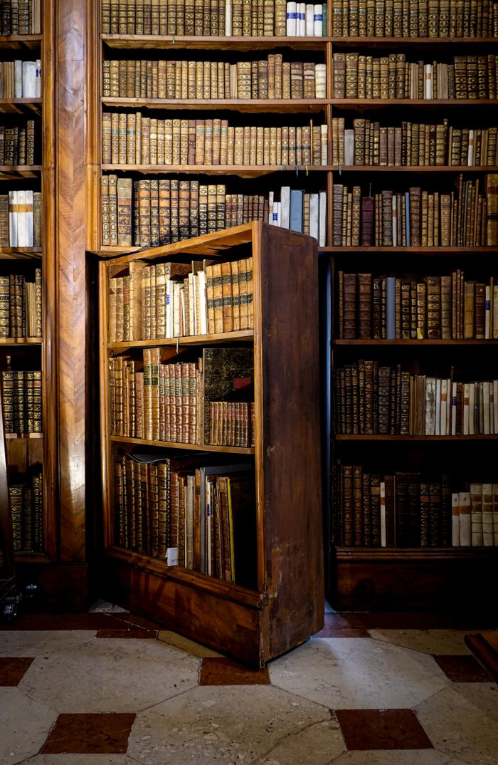 Explore the charm of a vintage library with secret bookshelf door.